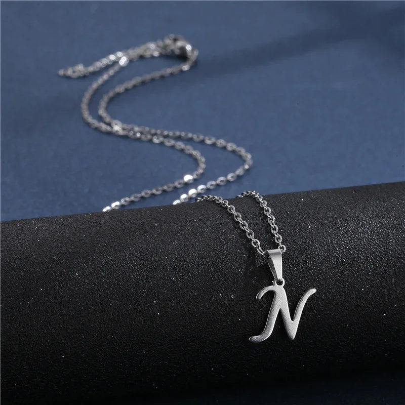 Shiny stainless steel initial letter pendant necklace for women, featuring a glossy clavicle chain choker jewelry piece.