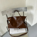 Luxury PU leather women's handbag with spacious design, shoulder strap, and stylish tote for commuting and office use.