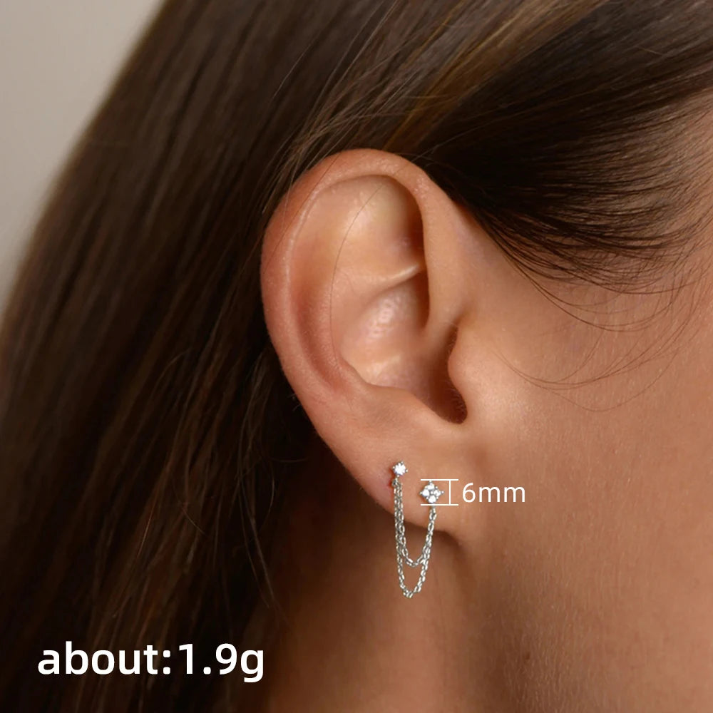 Luxury CZ double ear studs with tassel chains for women, featuring sparkling cubic zirconia and dangling chain details