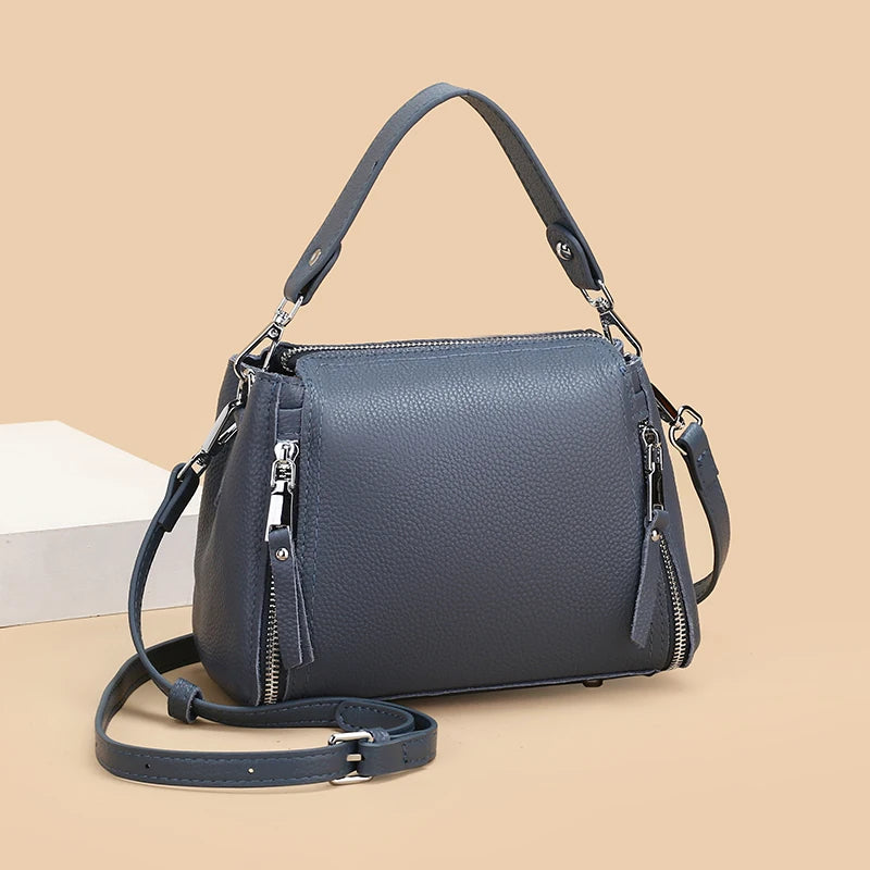 Genuine leather women's messenger handbag with high capacity, crossbody strap, and luxury cowhide design, ideal for travel and daily use.