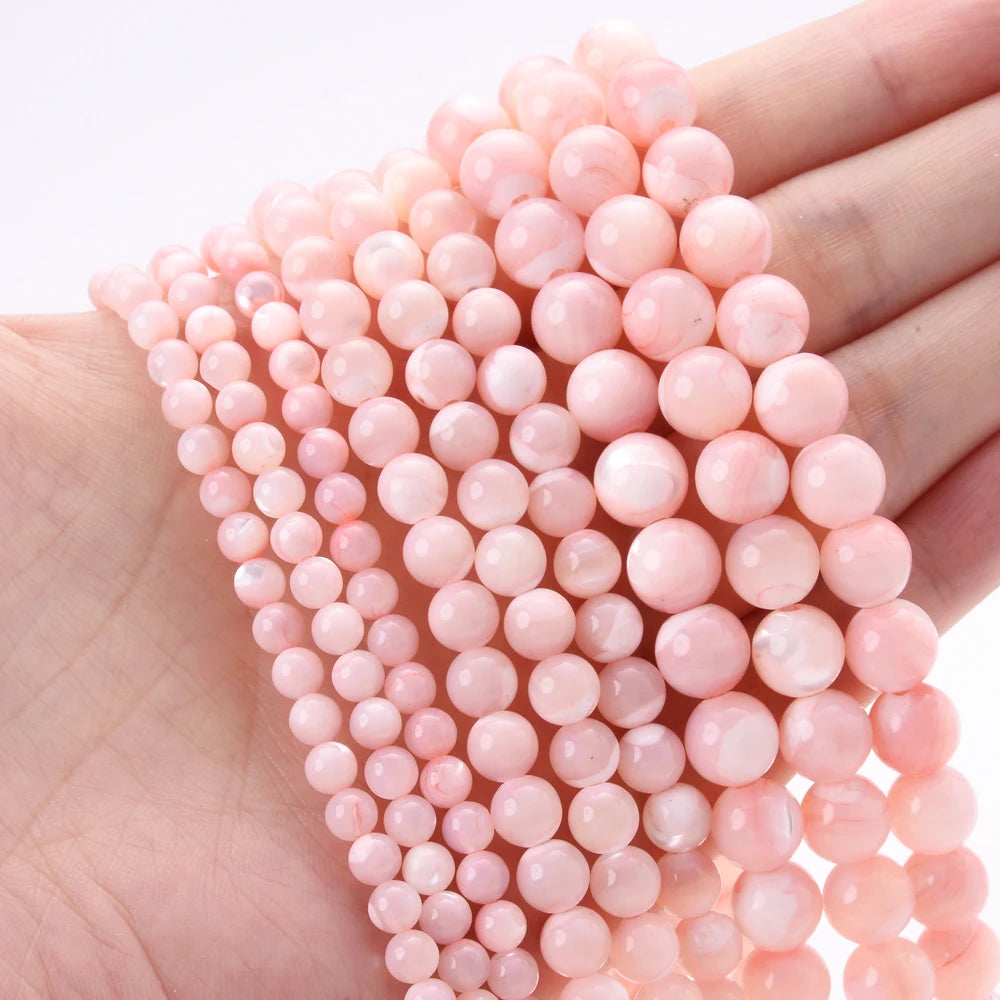 Natural freshwater shell pearls beads for jewelry making, displayed as loose round beads