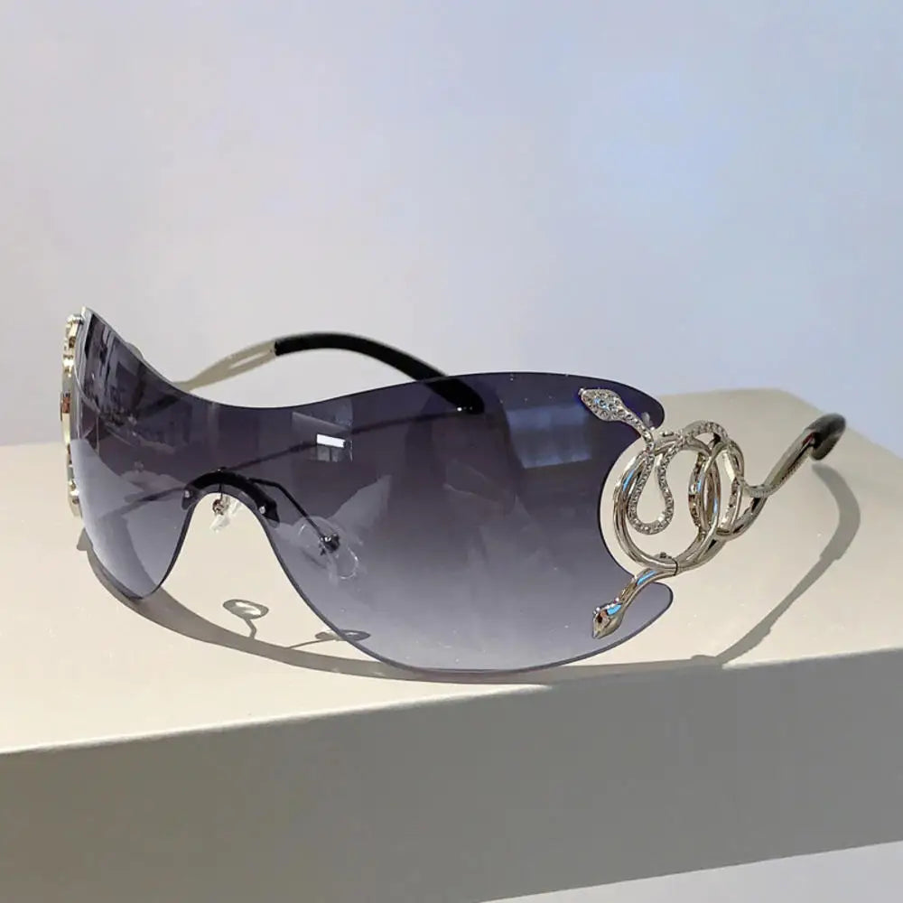 Y2K rimless sunglasses for women with snake-ray metal legs, gradient wrap-around lenses, stylish punk-inspired eyewear.