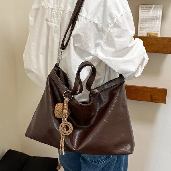 Luxury PU leather women’s handbag with spacious design, shoulder strap, and elegant style for commuting and office use.