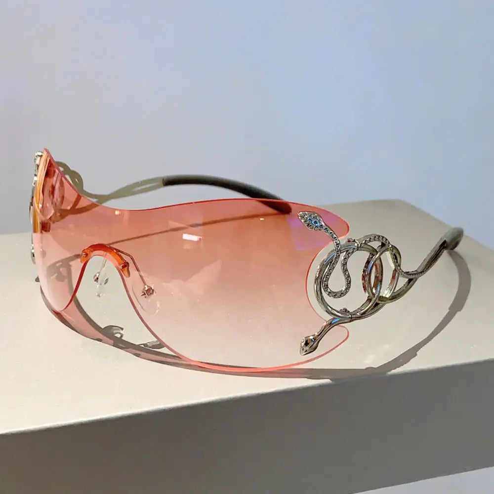 Y2K rimless sunglasses for women with snake pattern accents, metal legs, gradient lenses, wrap-around punk style eyewear.