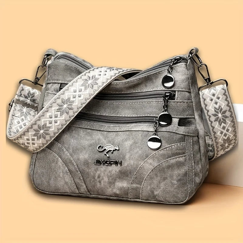 Vintage soft leather women's shoulder purse with multiple pockets and an ethnic pattern strap, ideal for everyday use.