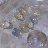 24-piece Y2K star press-on false nails with gradient blue French tips and gold moon designs in a sweet almond shape