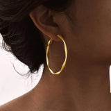 Stainless steel twist circle hoop earrings for women by HSF Marketplace