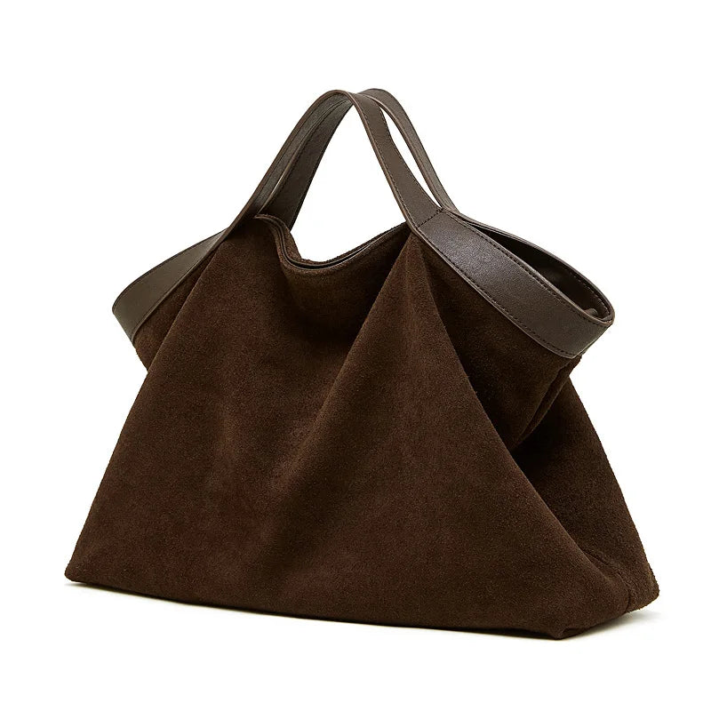Genuine leather women's handbag with large capacity, shoulder strap, and crossbody style, featuring cowhide design and spacious interior.