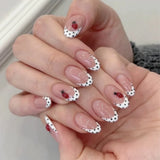 24-piece black polka dot press-on false nails, short round French tip design by HSF Marketplace