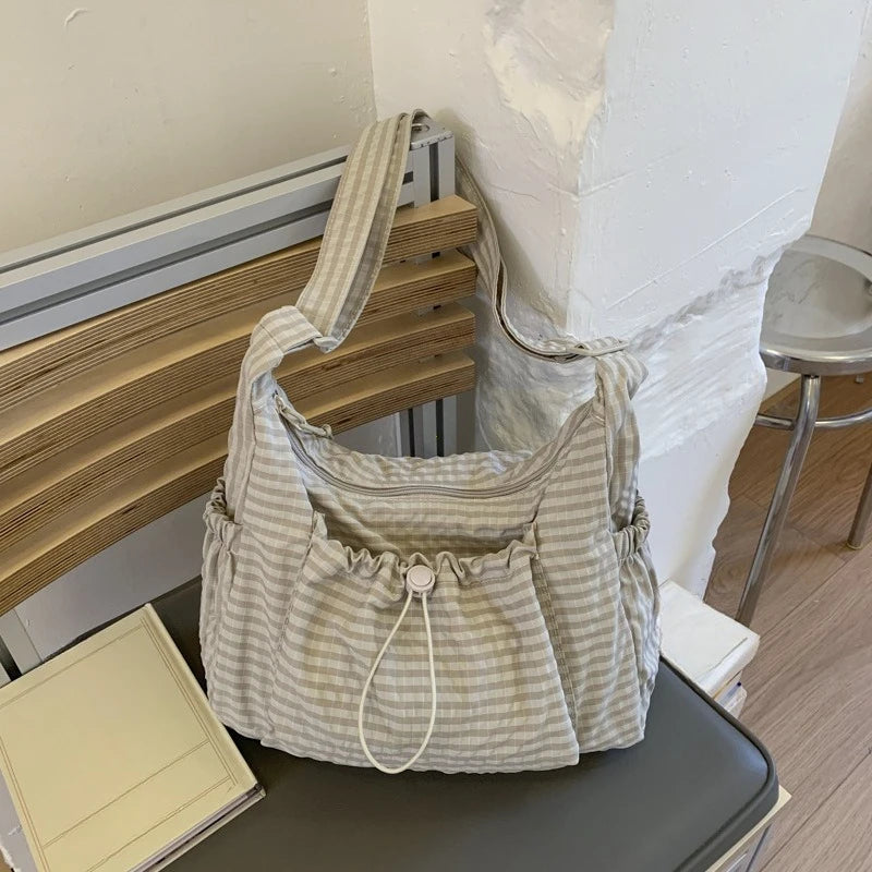 Women checkered nylon sling bag by HSF Marketplace featuring a drawstring crossbody design and large capacity satchel style.