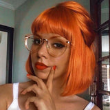 Orange blonde short straight bob wig with bangs, human hair, Brazilian style, machine-made, featuring a sleek cut and vibrant color.