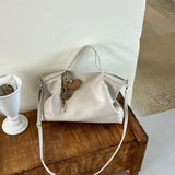 Luxury PU leather women's handbag with spacious design, shoulder strap, and elegant style for commuting and office use.