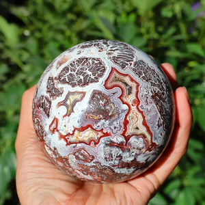 A stunning money agate ball with yellow and blue patterns, perfect for home and garden decoration.