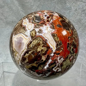 A stunning money agate ball with yellow and blue patterns, perfect for home and garden decoration.