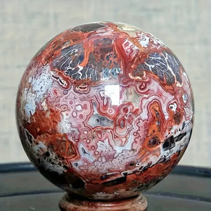 A stunning money agate ball with yellow and blue patterns, perfect for home and garden decoration.