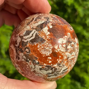 A stunning money agate ball with yellow and blue patterns, perfect for home and garden decoration.