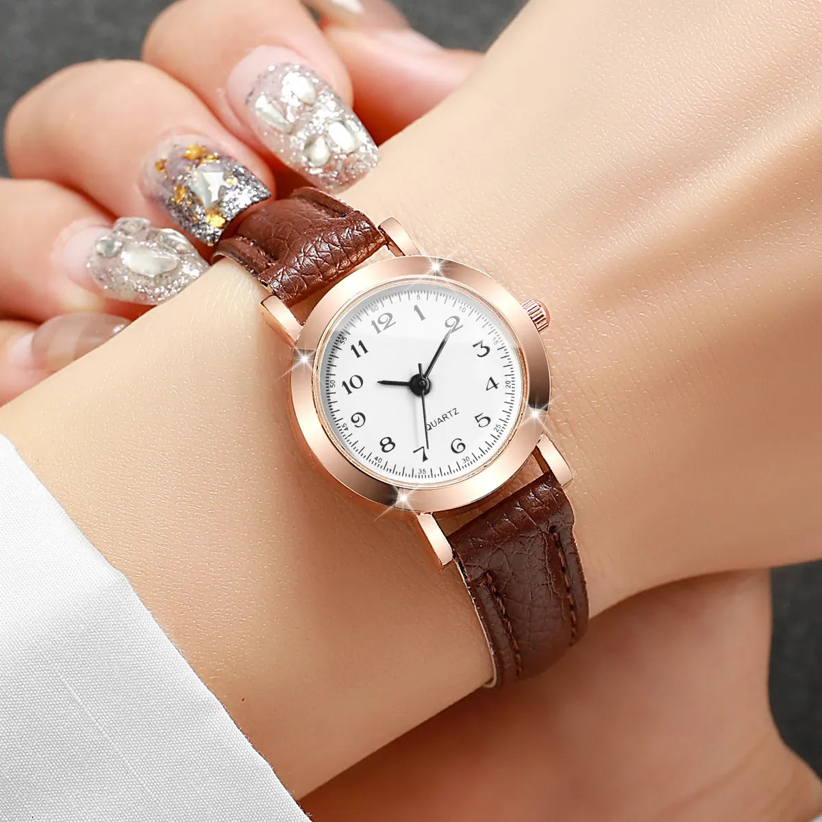 Women's fashion wristwatch with small dial, leather band, and analog quartz movement by HSF Marketplace.